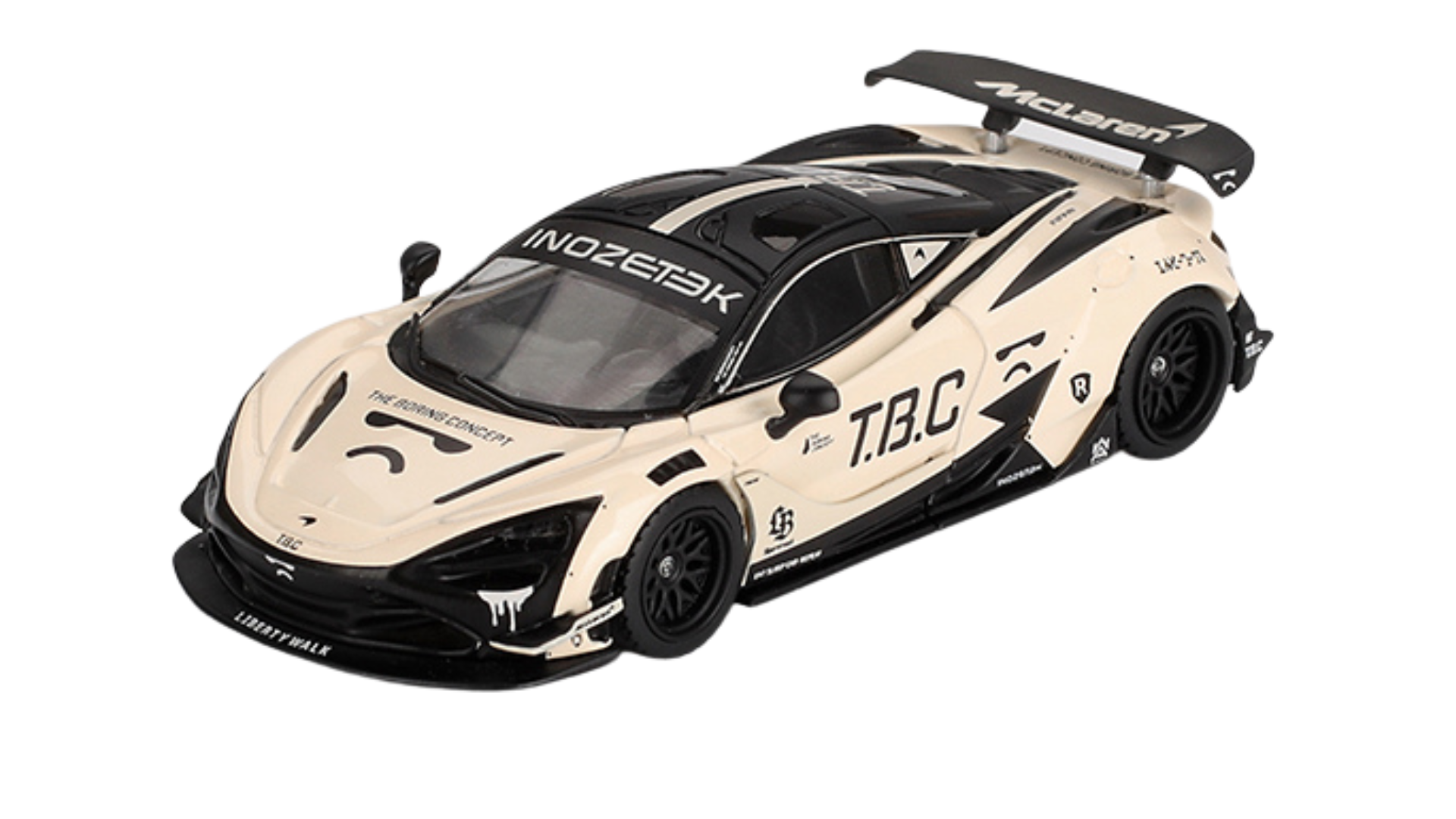 Model samochodu w kolorze beżowym z czarnymi akcentami i napisami, w tym \'T.B.C\' oraz \'INOZETEK\'. Na tylnym spojlerze widoczne jest logo \'McLaren\'.