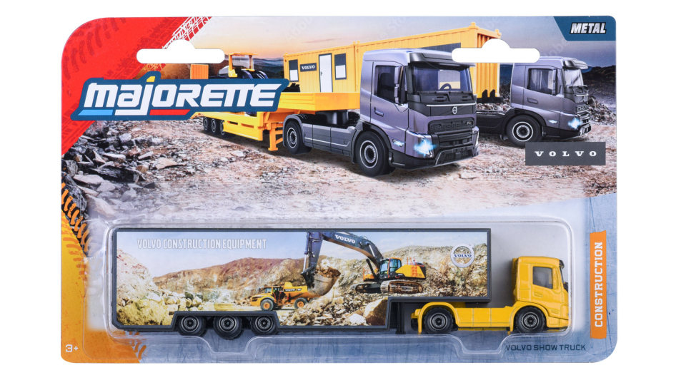 Opakowanie zabawkowej ciężarówki z serii Majorette Construction, przedstawiające model Volvo Show Truck w skali 1:87. Na opakowaniu widoczne są ilustracje ciężarówek oraz napis \'VOLVO CONSTRUCTION EQUIPMENT\'.