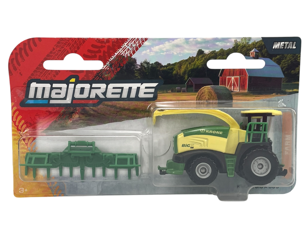 Opakowanie z zabawkowym kombajnem w kolorze zielono-żółtym z napisem \'KRONE BIG X 580\'. W tle widoczny jest krajobraz wiejski z budynkami i belami siana, a na opakowaniu znajduje się logo \'majorette\'.