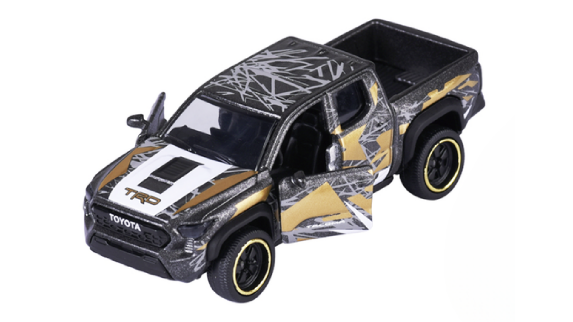 Model samochodu terenowego w skali 1:64 z otwartymi drzwiami, ozdobiony wzorami w kolorach czarnym, białym i złotym. Na masce widoczne są napisy \'TRD\' i \'Toyota\'.