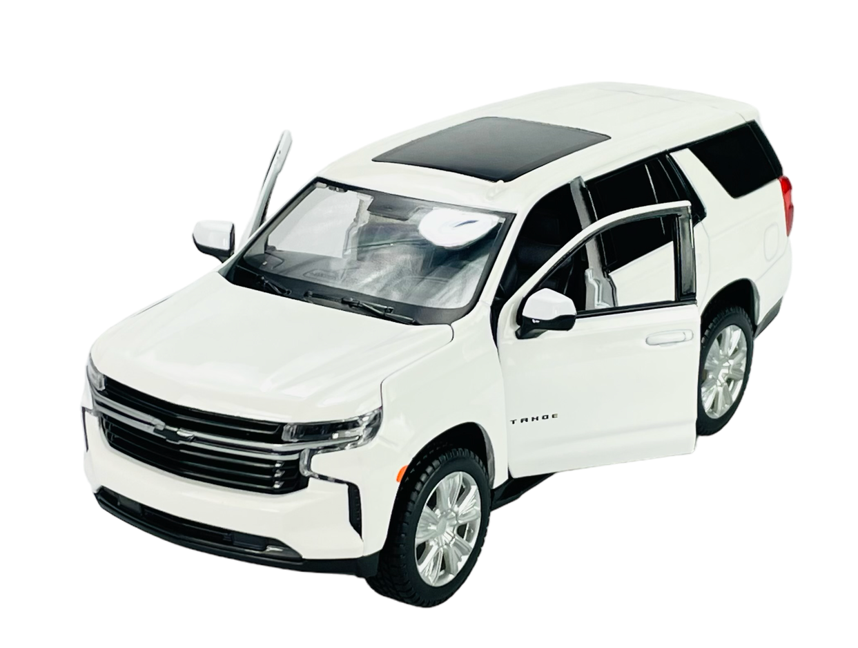 Biały model samochodu Chevrolet Tahoe z otwartymi drzwiami i widocznym wnętrzem. Na boku pojazdu widoczny jest napis \'Tahoe\'.