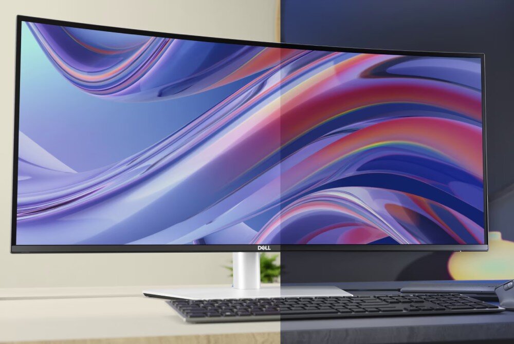 Monitor o zakrzywionym ekranie wyświetla kolorowe, abstrakcyjne wzory. Na dolnej ramce widoczne jest logo \'DELL\'.
