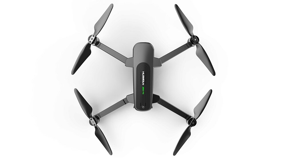 Na obrazie widoczny jest dron z czterema śmigłami, na którego korpusie znajduje się napis \'HUBSAN Zino Pro\'.