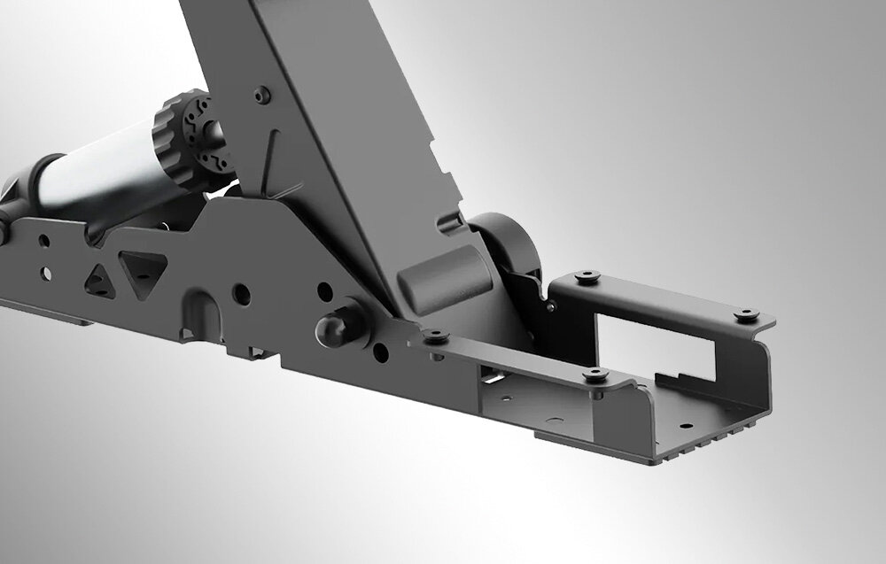 Obraz przedstawia metalowy element konstrukcyjny z widocznymi otworami montażowymi i mechanizmem sprężynowym. Tło jest jednolite, szare.