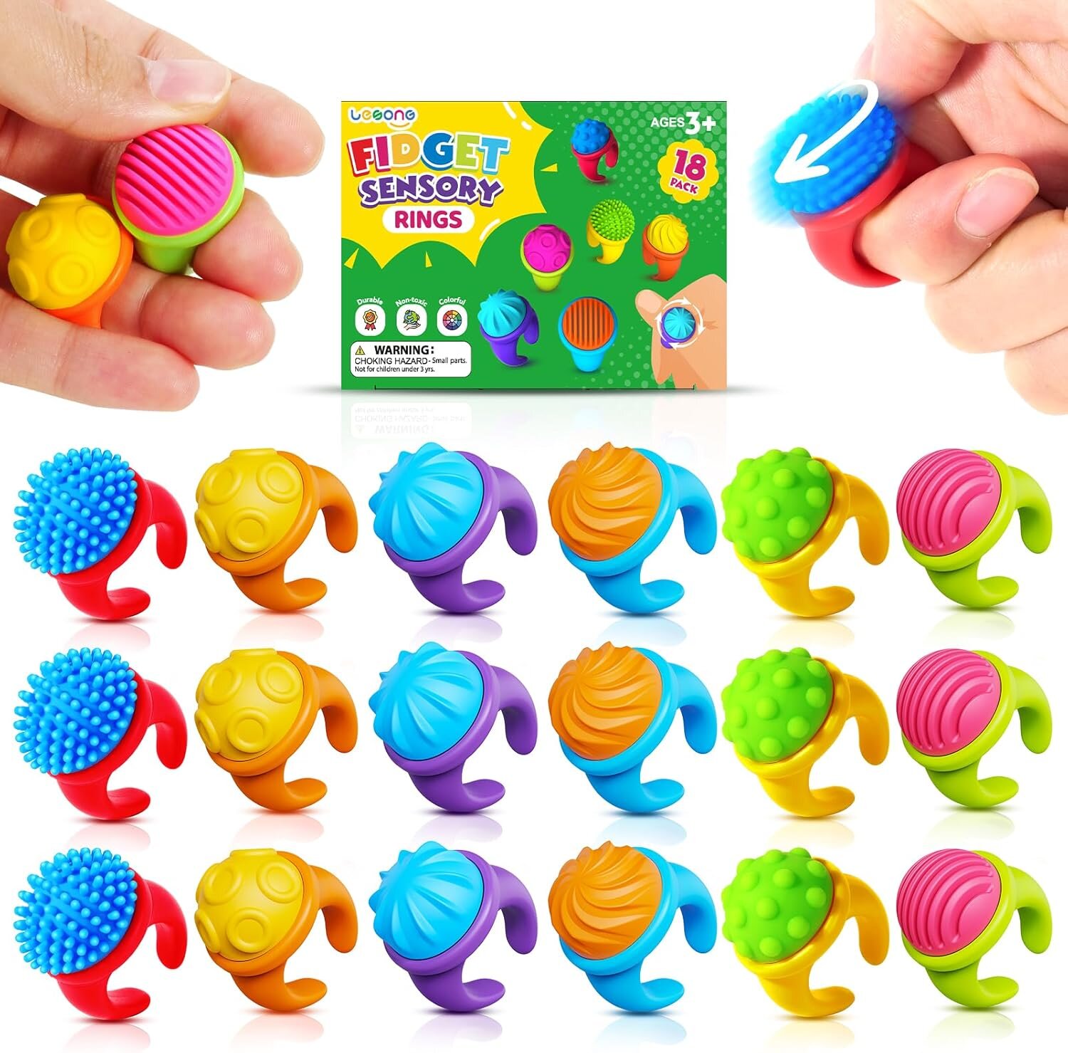 Obraz przedstawia zestaw kolorowych sensorycznych pierścionków z różnymi fakturami, zapakowanych w pudełko z napisem \'Fidget Sensory Rings\'. Na opakowaniu widnieje informacja \'Ages 3+\' oraz ostrzeżenie \'WARNING: CHOKING HAZARD - Small parts. Not for children under 3 yrs.\'.