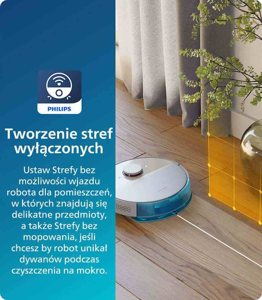 Obraz przedstawia robot sprzątający na drewnianej podłodze obok zasłony i rośliny, z zaznaczoną strefą wyłączoną w kolorze pomarańczowym. Po lewej stronie znajduje się tekst: \'Tworzenie stref wyłączonych Ustaw Strefy bez możliwości wjazdu robota dla pomieszczeń, w których znajdują się delikatne przedmioty, a także Strefy bez mopowania, jeśli chcesz by robot unikał dywanów podczas czyszczenia na mokro.\' oraz logo PHILIPS.