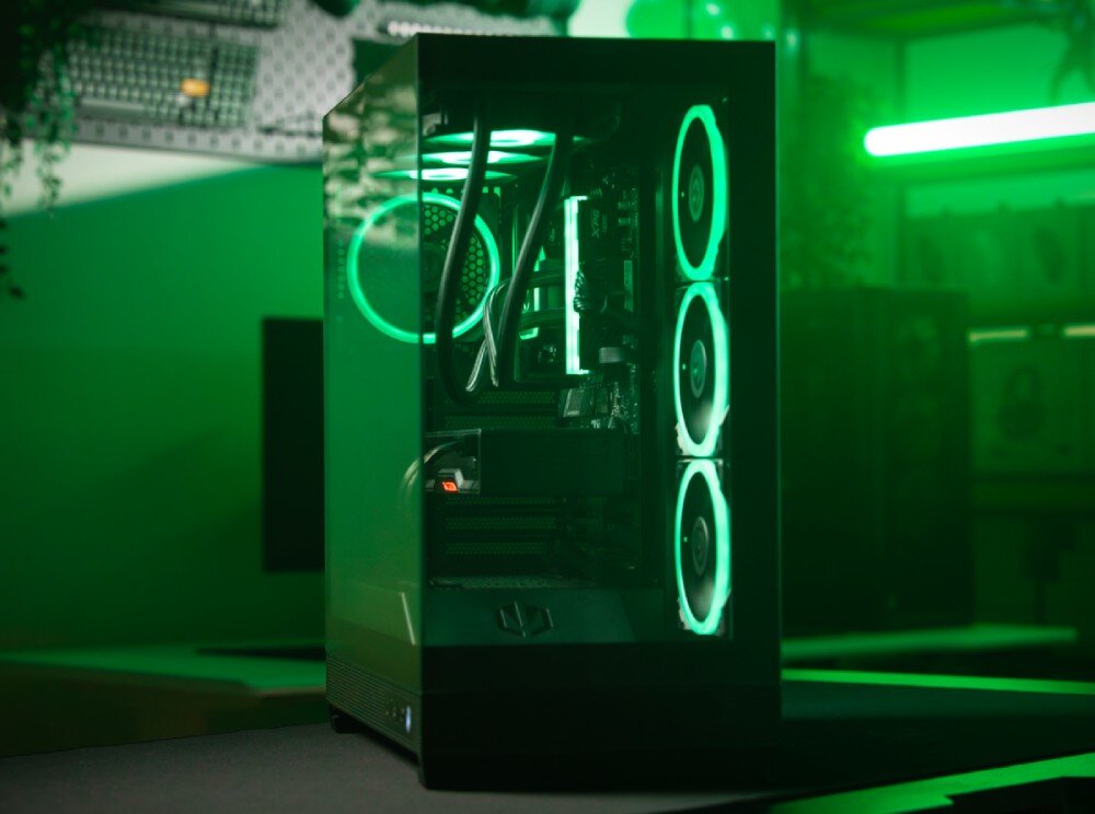Komputer MAD DOG SIMRACE-A05WR32WPV2 Czarna obudowa komputerowa typu showcase z dwoma przeszklonymi panelami, przez które widać podświetlone na zielono wnętrze, w tym cztery wentylatory z pierścieniami świetlnymi, podzespoły, przeznaczenie, testy