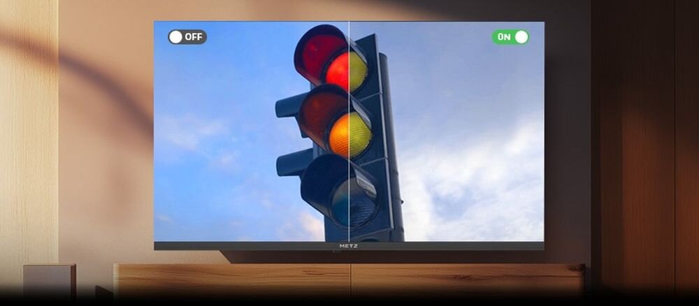 Telewizor METZ wyświetla obraz sygnalizacji świetlnej z czerwonym, żółtym i zielonym światłem. Na ekranie widoczne są napisy \'OFF\' i \'ON\'.
