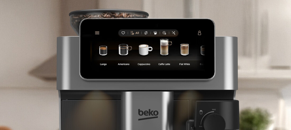 Ekspres do kawy z wyświetlaczem dotykowym pokazującym różne rodzaje kaw: Lungo, Americano, Cappuccino, Caffe Latte, Flat White. Na obudowie widoczne jest logo \'beko\'.
