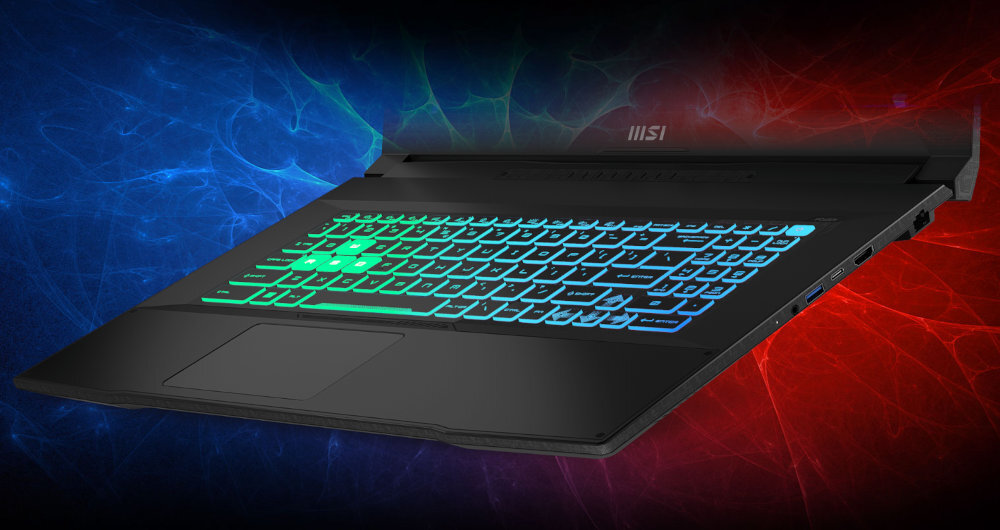Laptop z podświetlaną klawiaturą w kolorach zielonym i niebieskim, na tle gradientu niebiesko-czerwonego. Widoczne logo: MSI.