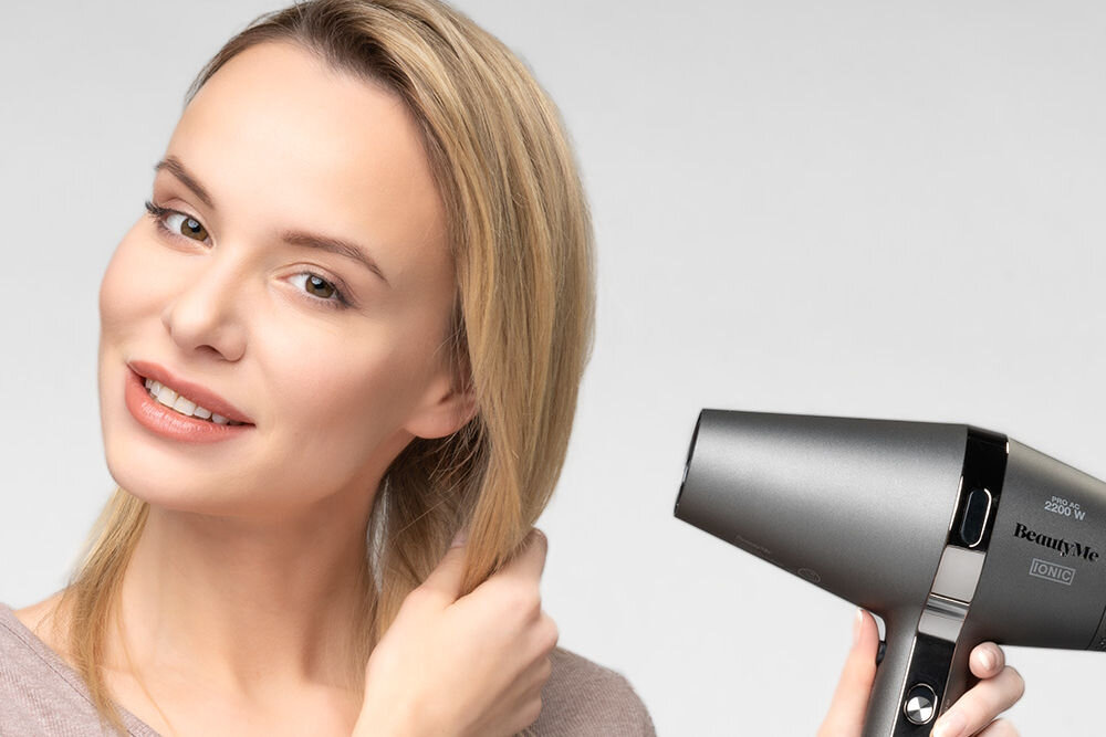 Osoba trzyma suszarkę do włosów o nazwie BeautyMe Keratin Intense HD925 2200W. Na suszarce widoczne jest logo \'BeautyMe\' oraz napis \'2200 W IONIC\'.