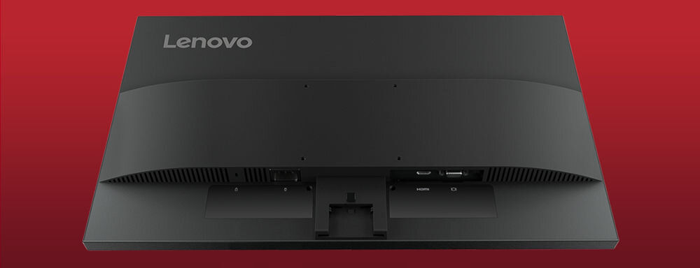 Czarny monitor Lenovo z widocznymi portami z tyłu obudowy na tle czerwonym. Na obudowie znajduje się logo \'Lenovo\'.