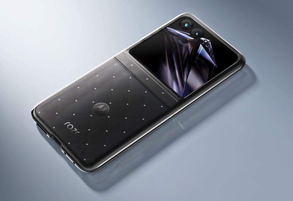Na obrazie widoczny jest składany smartfon z wyświetlaczem i dwoma aparatami. Na obudowie znajduje się logo w kształcie litery \'M\' oraz napis \'razr\'.