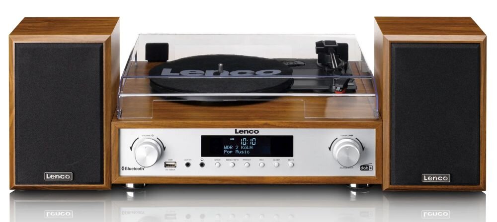Gramofon w drewnianej obudowie z przezroczystą pokrywą, wyposażony w dwa głośniki. Na panelu przednim widoczne są pokrętła, wyświetlacz oraz logo \'Lenco\'.