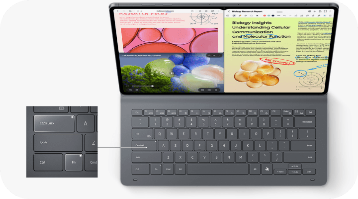 Tablet z klawiaturą, na ekranie widoczne są kolorowe grafiki i teksty dotyczące biologii. Obok znajduje się powiększenie klawisza \'Caps Lock\'.