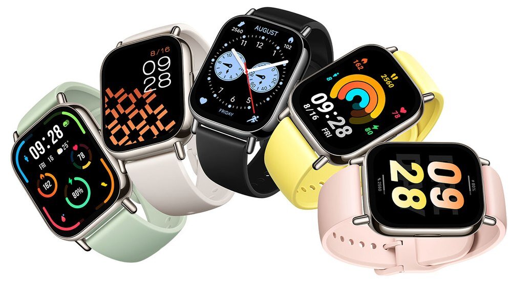 Na obrazie widoczne są cztery smartwatche z różnymi kolorami pasków: czarnym, żółtym, różowym i zielonym. Każdy zegarek ma inny wyświetlacz z różnymi tarczami i informacjami, takimi jak godzina, data i aktywność fizyczna.