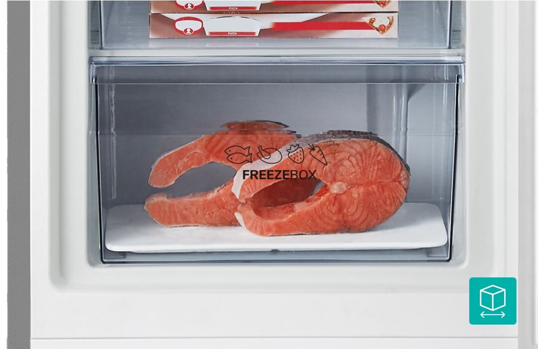 Wnętrze zamrażarki z przezroczystą szufladą, w której znajdują się dwa kawałki łososia. Na szufladzie widnieje napis \'FREEZEBOX\' oraz ikony ryby, mięsa i owocu.