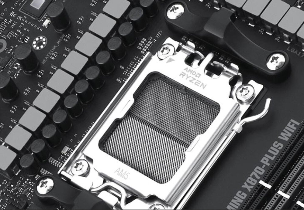 Zdjęcie przedstawia gniazdo procesora na płycie głównej z napisem \'AMD RYZEN\' oraz \'AM5\'. Widoczny jest również fragment napisu \'GAMING X870-PLUS WIFI\'.