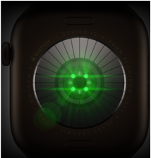 Tył zegarka z ciemnego materiału z widocznymi zielonymi diodami i napisami wokół krawędzi: \'WATCH SERIES 12 42MM ALUMINUM CASE\'.