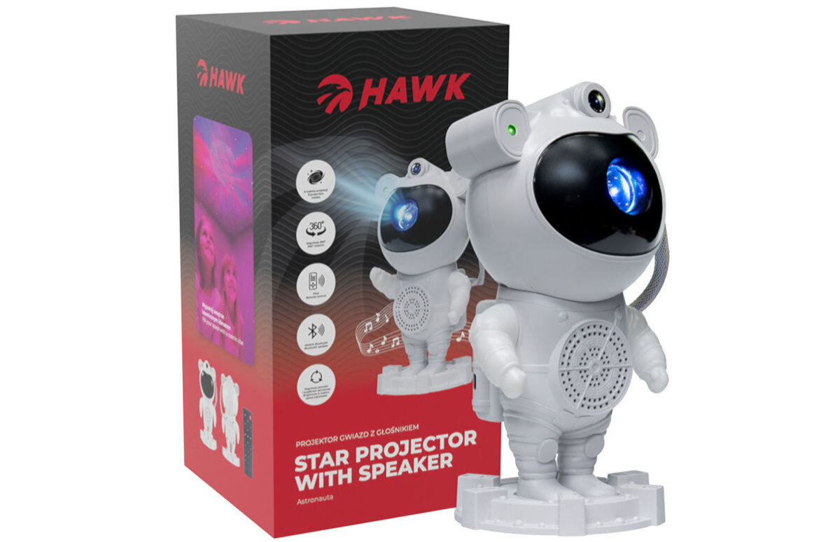 Na obrazie znajduje się biały projektor w kształcie astronauty z niebieskim światłem na przodzie, obok pudełka z logo \'HAWK\'. Na pudełku widnieje napis \'PROJEKTOR GWIAZD Z GŁOŚNIKIEM STAR PROJECTOR WITH SPEAKER ASTRONAUT\'.