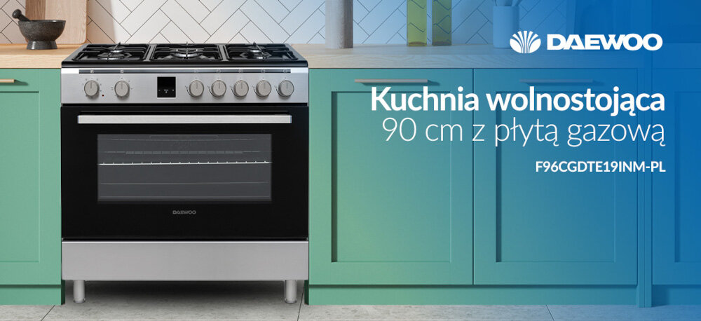 Kuchnia wolnostojąca z płytą gazową o szerokości 90 cm, model F96CGDTE19INM-PL, znajduje się pomiędzy zielonymi szafkami. Logo DAEWOO widoczne jest w prawym górnym rogu.