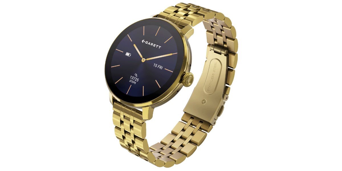 Złoty smartwatch z okrągłą tarczą, na której widnieje logo \'GARETT\' oraz data \'15 FR\'. Bransoleta zegarka jest wykonana z metalu o złotym kolorze.