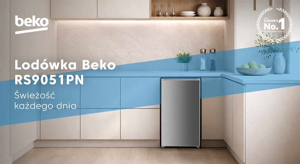 Kuchnia z lodówką Beko RS9051PN, otoczona szafkami i blatem w jasnych kolorach. Na obrazie widoczny jest tekst: \'Lodówka Beko RS9051PN Świeżość każdego dnia\'.