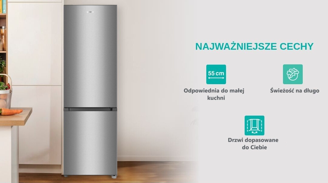 Na obrazie widoczna jest srebrna lodówka stojąca w kuchni oraz tekst: \'NAJWAŻNIEJSZE CECHY\', \'55 cm Odpowiednia do małej kuchni\', \'Świeżość na długo\', \'Drzwi dopasowane do Ciebie\'.