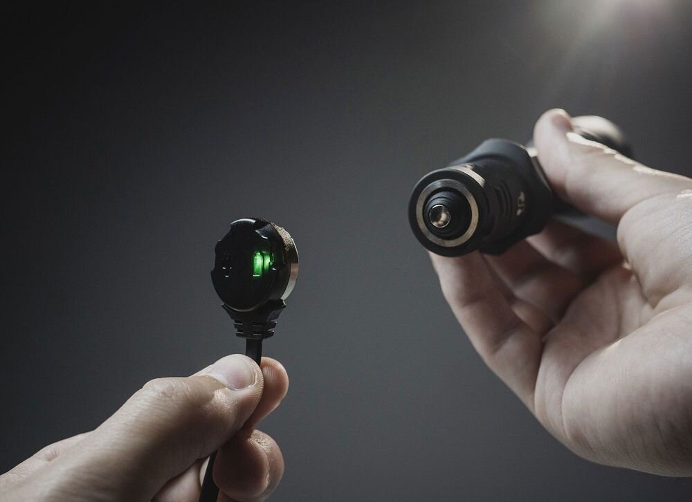 Ładowarka do latarek taktycznych ARMYTEK A05003 AMC-03, kabel, zasilanie, obudowa, outdoor, Zbliżanie magnetycznej końcówki kabla do portu latarki.