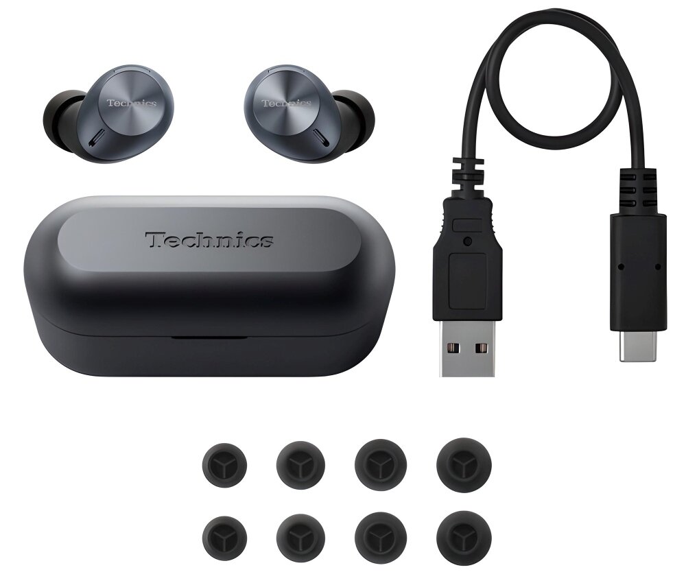 Na obrazie widoczne są czarne słuchawki dokanałowe z logo \'Technics\', etui ładujące z tym samym logo, kabel USB-C oraz zestaw wymiennych gumek do słuchawek.