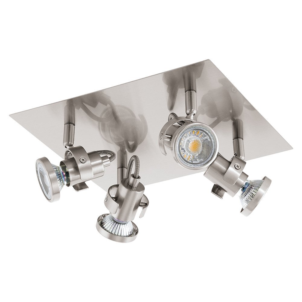 Na obrazie widoczna jest lampa spot reflektorowa z trzema regulowanymi źródłami światła zamontowanymi na prostokątnej, metalowej podstawie. Każde źródło światła ma cylindryczny kształt i jest wykonane z metalu.