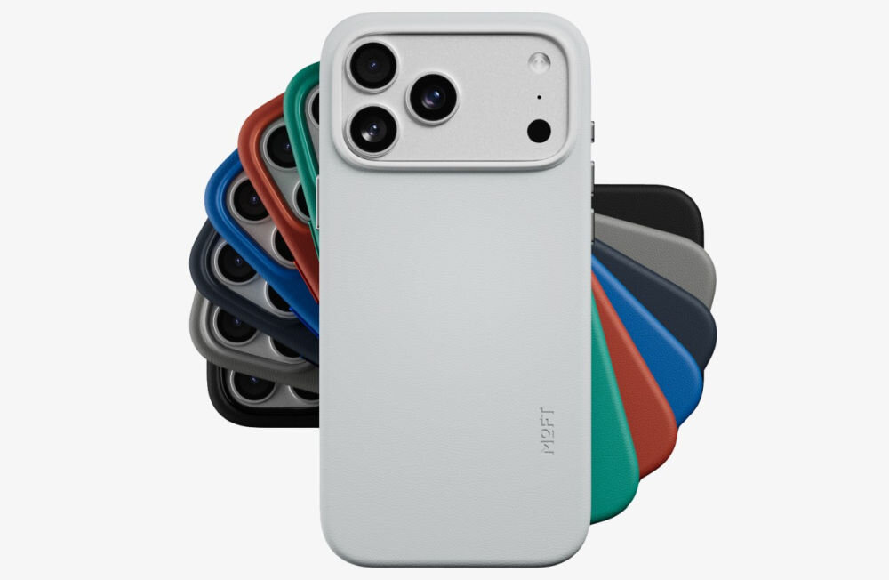 Na obrazie widoczne jest etui na telefon w kolorze jasnoszarym z trzema otworami na aparaty fotograficzne oraz logo \'MOFT\'. W tle znajduje się wachlarz etui w różnych kolorach, takich jak czerwony, zielony, niebieski i czarny.