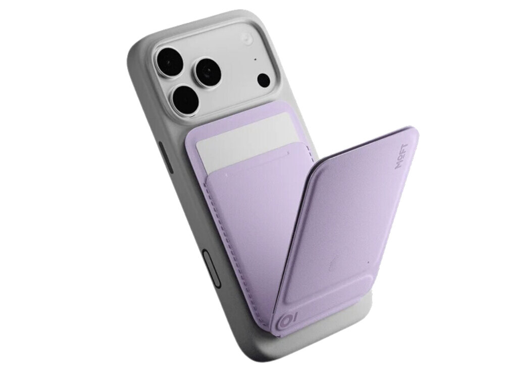 Na obrazie widoczny jest telefon z zamontowanym fioletowym magnetycznym portfelem i stojakiem. Na portfelu znajduje się logo \'MOFT\'.