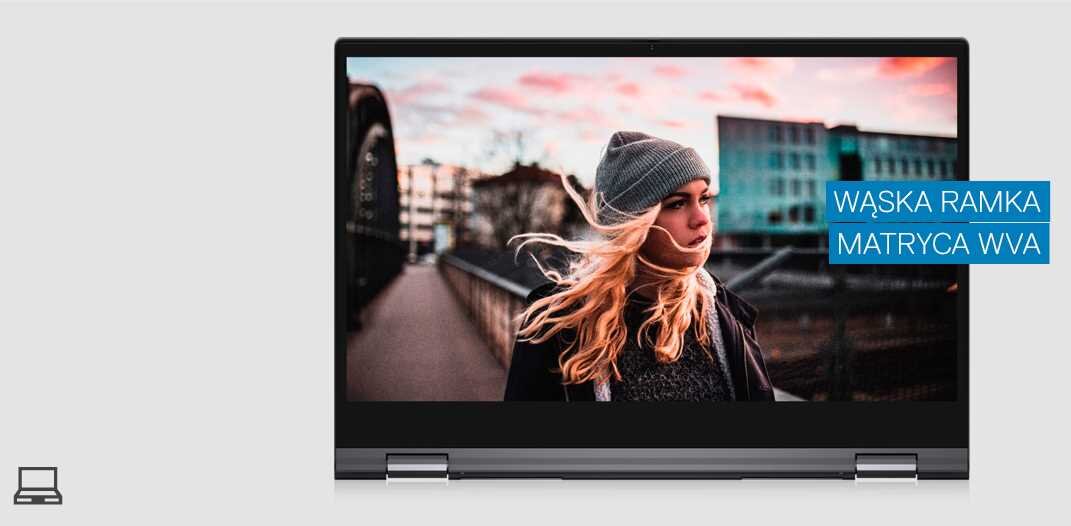 Laptop z wyświetlaczem pokazującym osobę na tle miejskiego krajobrazu. Obok ekranu znajduje się napis \'WĄSKA RAMKA MATRYCA WVA\'.