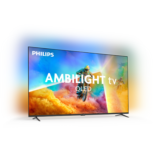 Telewizor z napisem \'PHILIPS AMBILIGHT tv QLED\' wyświetla dynamiczną scenę z motocyklistą na tle kolorowych chmur. Ekran otoczony jest efektem świetlnym Ambilight, który rozprasza kolorowe światło wokół telewizora.