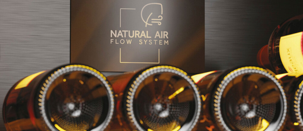 Na obrazie widoczne są butelki wina ułożone poziomo, a w tle znajduje się napis \'NATURAL AIR FLOW SYSTEM\'.