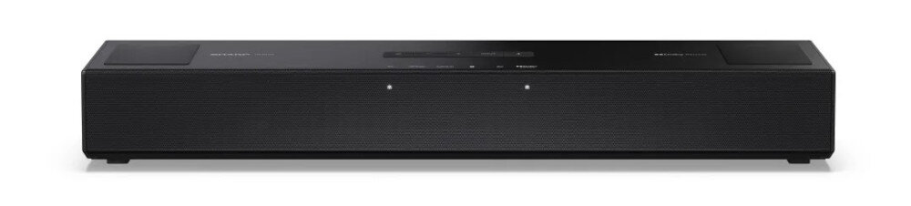 Czarny soundbar z widocznymi przyciskami na górnej powierzchni i dwoma małymi diodami na przednim panelu. Na górze widoczne są napisy: \'SHARP\' i \'Dolby Atmos\'.