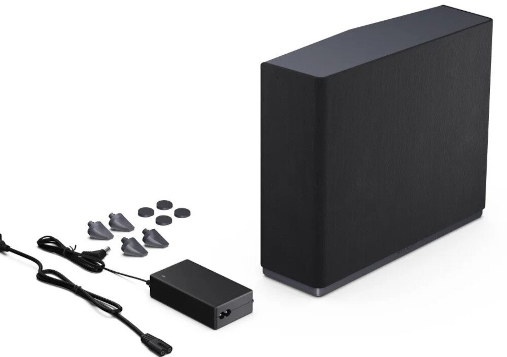 Na obrazie znajduje się czarny subwoofer o prostokątnym kształcie, obok którego leżą kable, zasilacz oraz kilka małych, okrągłych elementów. Produkt jest przeznaczony do użytku z telewizorami SHARP serii FQ i GR.