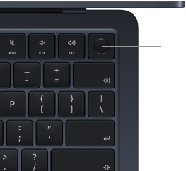 Fragment klawiatury laptopa z widocznymi klawiszami funkcyjnymi F10, F11, F12 oraz przyciskiem zasilania w górnym rogu. Klawisze mają ciemny kolor z białymi symbolami.