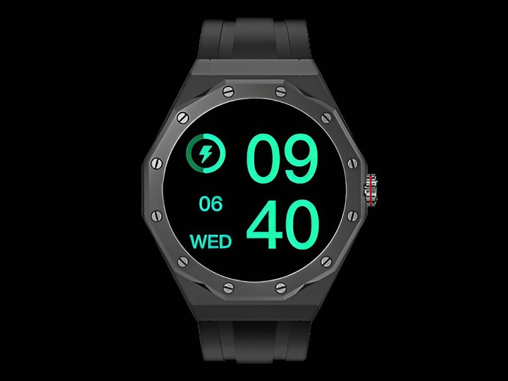 Smartwatch z czarnym paskiem i okrągłym wyświetlaczem, na którym widoczna jest godzina 09:40, dzień tygodnia WED oraz data 06. Na ekranie znajduje się również ikona baterii.