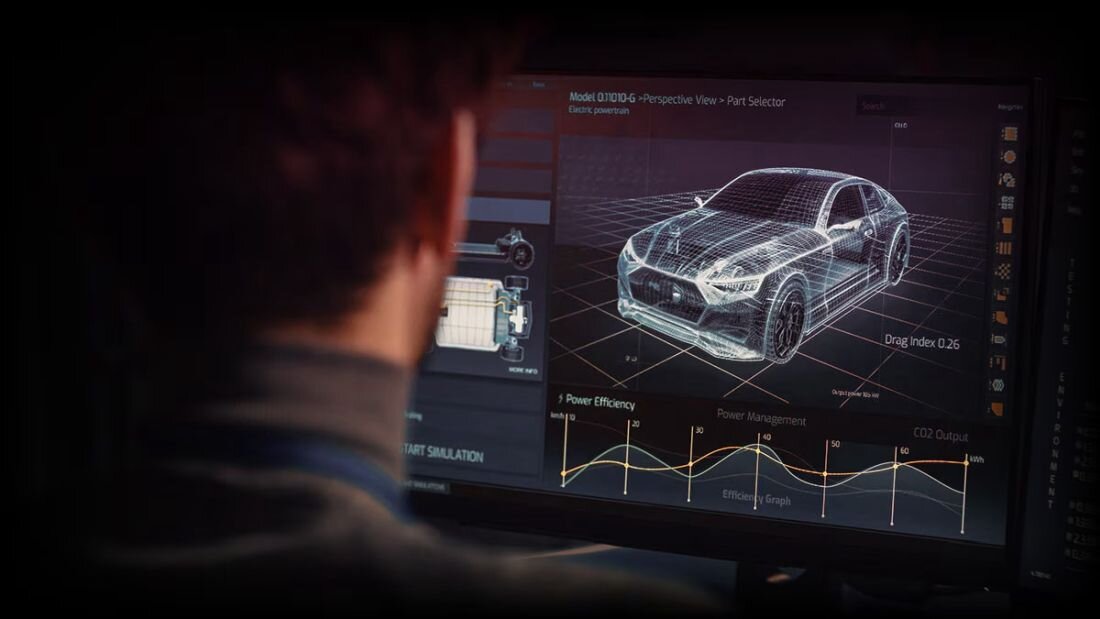 Osoba patrzy na ekran komputera, na którym wyświetlany jest model 3D samochodu z danymi technicznymi i wykresami dotyczącymi wydajności. Widoczny jest tekst: \'Model QX10D-G - Perspective View - Part Selector\' oraz \'Drag Index 0.26\'.