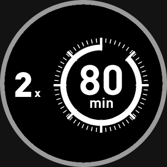 Czarny okrągły symbol z białymi oznaczeniami, przedstawiający liczby \'2 x\' oraz \'80 min\' w centralnej części, otoczone białymi kreskami przypominającymi zegar.