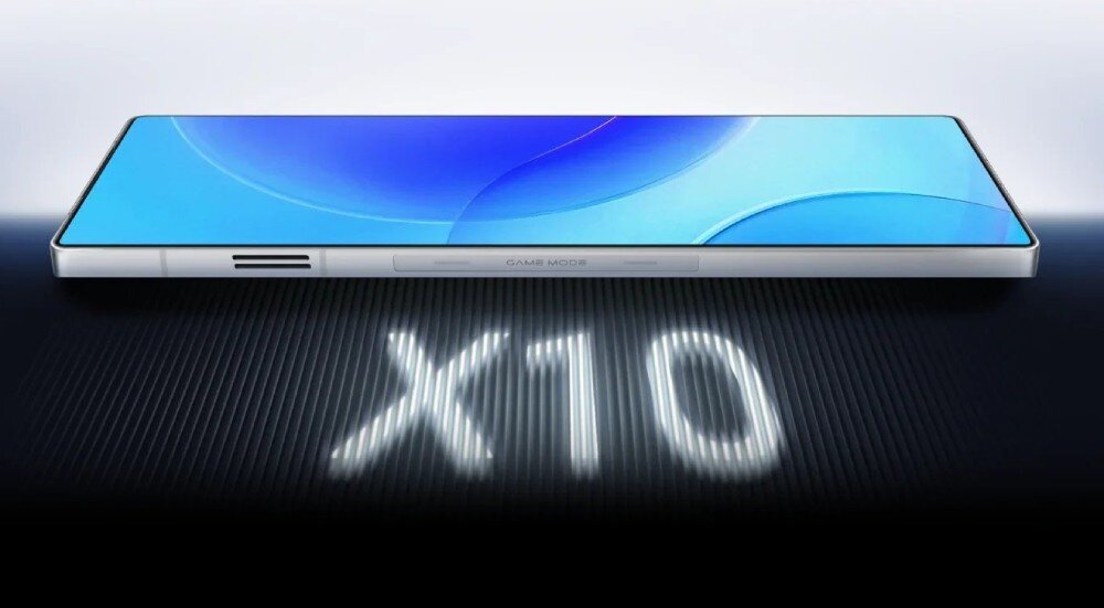 Smartfon REDMAGIC 11 Pro 5G Leżący poziomo smartfon z włączonym wyświetlaczem, a pod nim widoczny duży, świetlny napis 'X10'