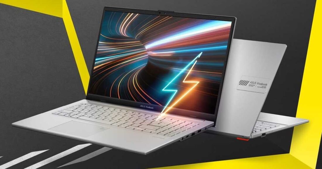 Na obrazie widoczny jest laptop z otwartym ekranem, na którym wyświetlane są dynamiczne, kolorowe linie. Obok znajduje się zamknięty laptop z logo \'ASUS VivoBook\' na obudowie.