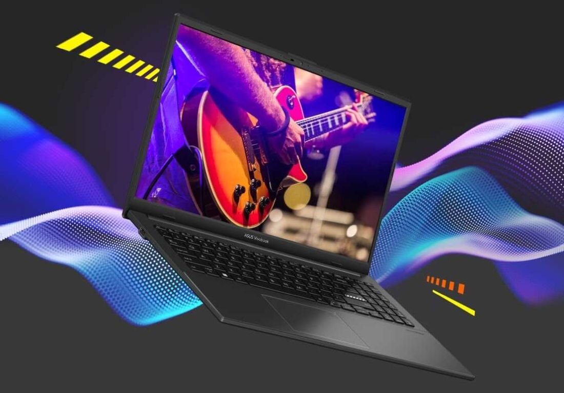 Laptop z wyświetlaczem pokazującym osobę grającą na gitarze elektrycznej. Na obudowie widoczne jest logo \'ASUS VivoBook\'.