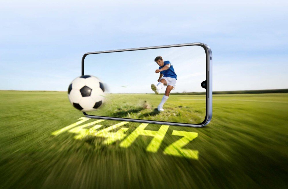 Smartfon REALME C100 5G Smartfon wyświetlający piłkarza uderzającego piłkę na tle boiska z podświetlonym napisem '144Hz' na trawie
