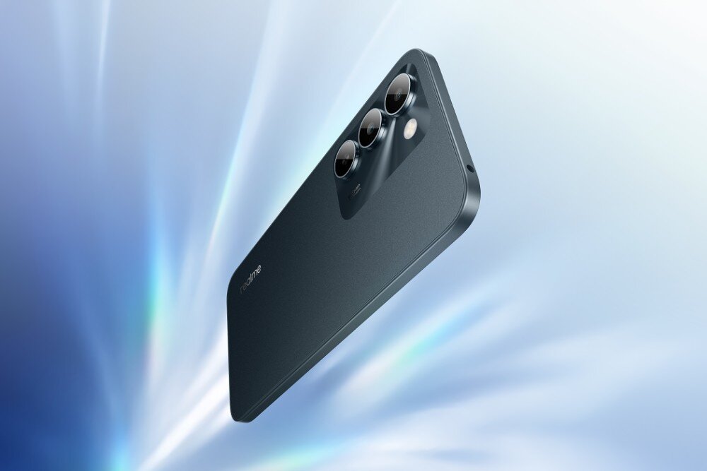 Smartfon REALME C100 5G Tylny panel smartfona z trzema obiektywami i diodą doświetlającą, ukazany pod kątem na tło z jasnymi promieniami