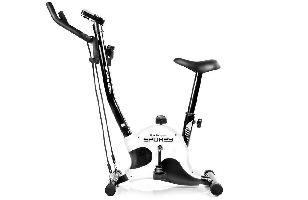 Rower mechaniczny z czarnym siodełkiem i uchwytami, na białej obudowie widoczne logo \'Spokey One Go\'. Urządzenie posiada pedały i stabilną podstawę.