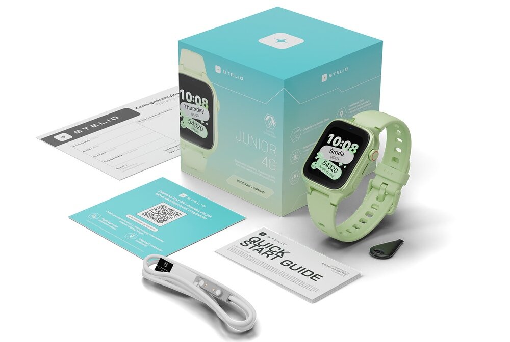 Na obrazie znajduje się pistacjowy smartwatch z wyświetlaczem pokazującym godzinę 10:08 i dzień tygodnia \'Środa\'. Obok zegarka widoczne są pudełko z napisem \'JUNIOR 4G\', przewód do ładowania, instrukcja \'QUICK START GUIDE\' oraz karta z kodem QR.