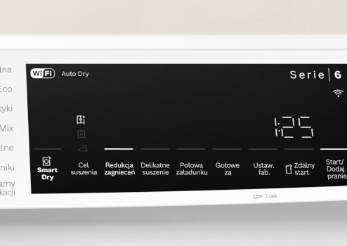 Panel sterowania suszarki z wyświetlaczem pokazującym czas 1:25 oraz ikonami i napisami: WiFi, Auto Dry, Serie 6, Smart Dry, Cel suszenia, Redukcja zagnieceń, Delikatne suszenie, Połowa załadunku, Gotowe za, Ustaw. fab., Zdalny start, Start/Dodaj pranie.